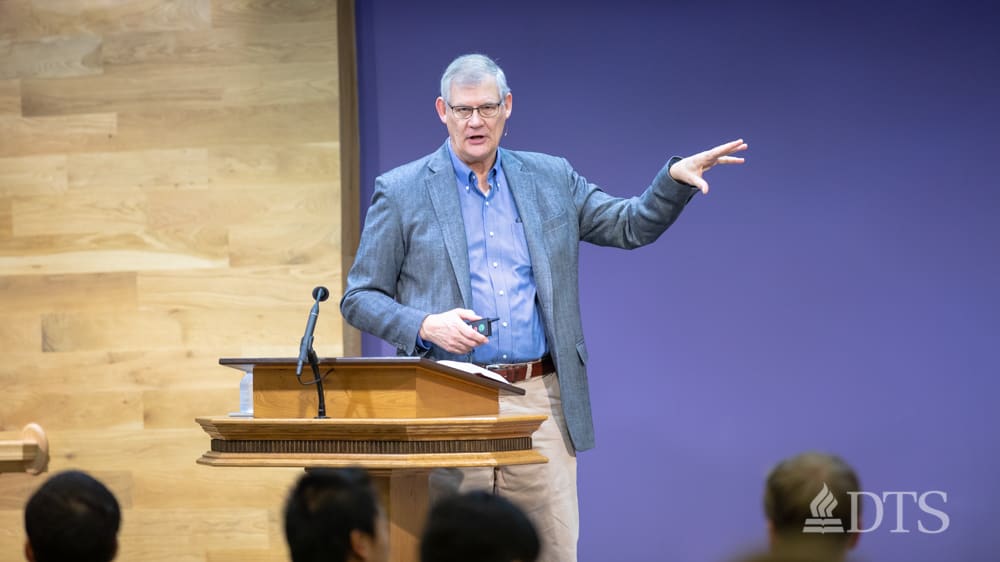 man standing at podium speaking at DTS Chapel