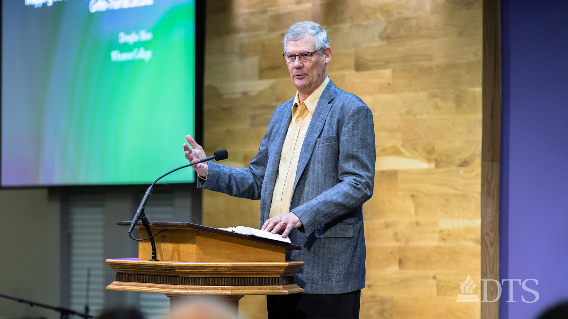 man standing at podium speaking at DTS Chapel
