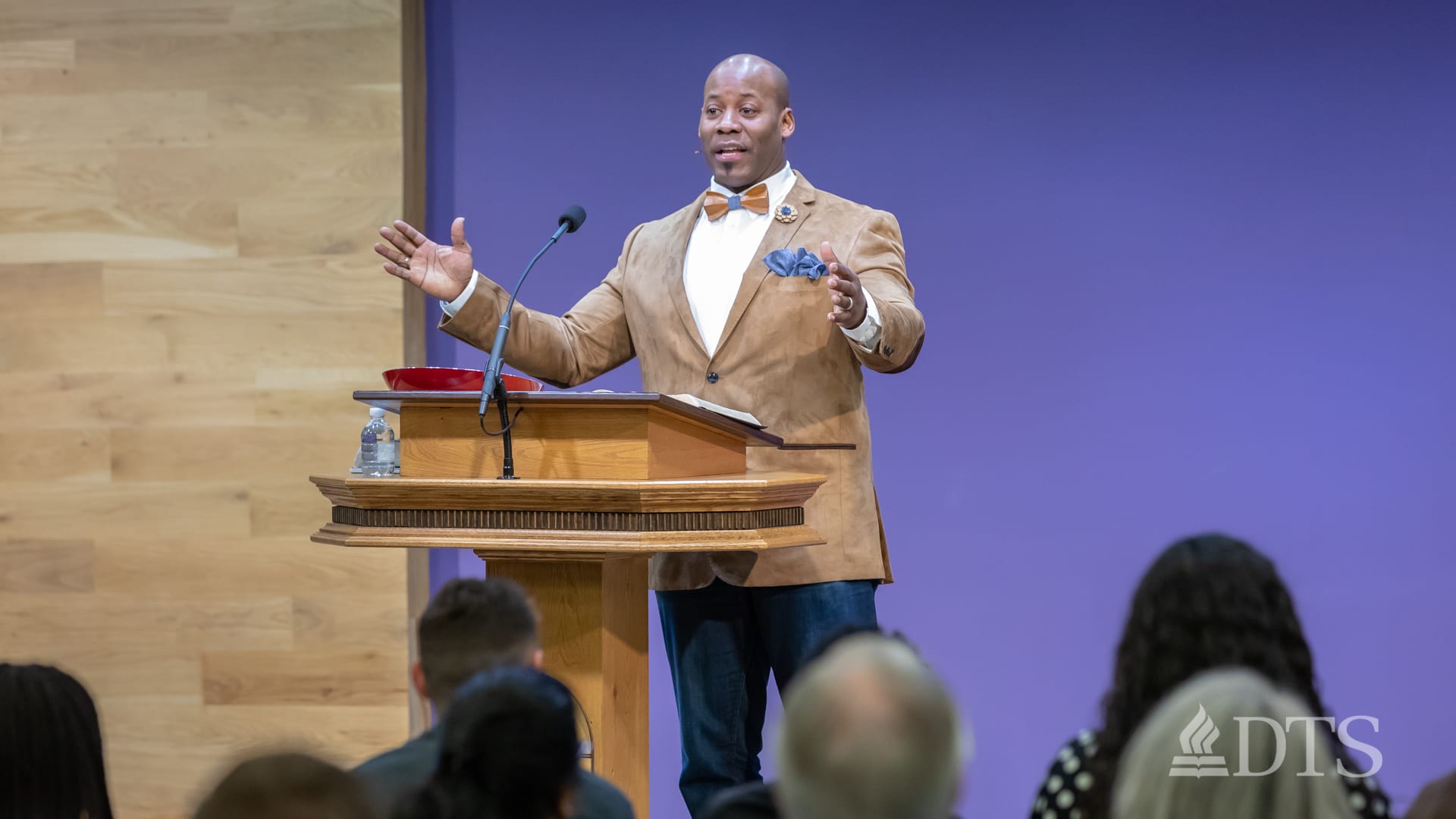 man standing at podium speaking at DTS Chapel