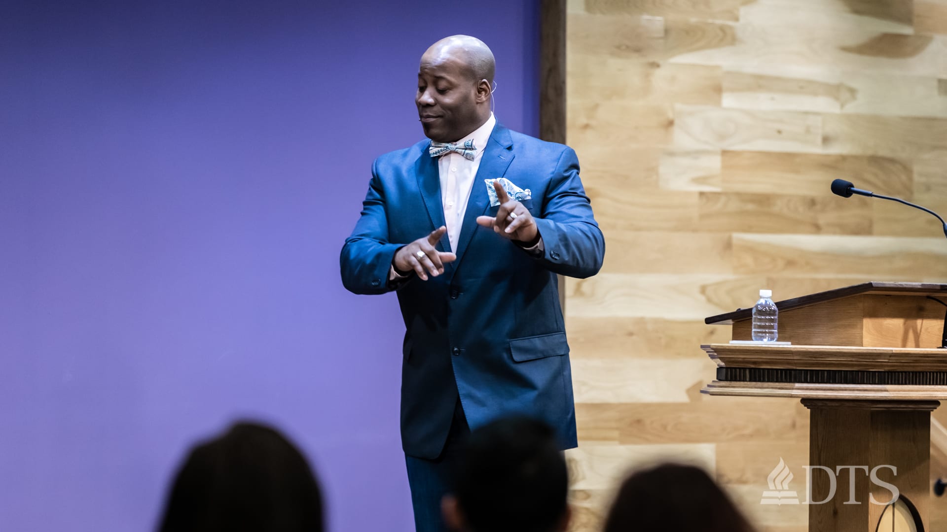 man standing near podium speaking at DTS Chapel