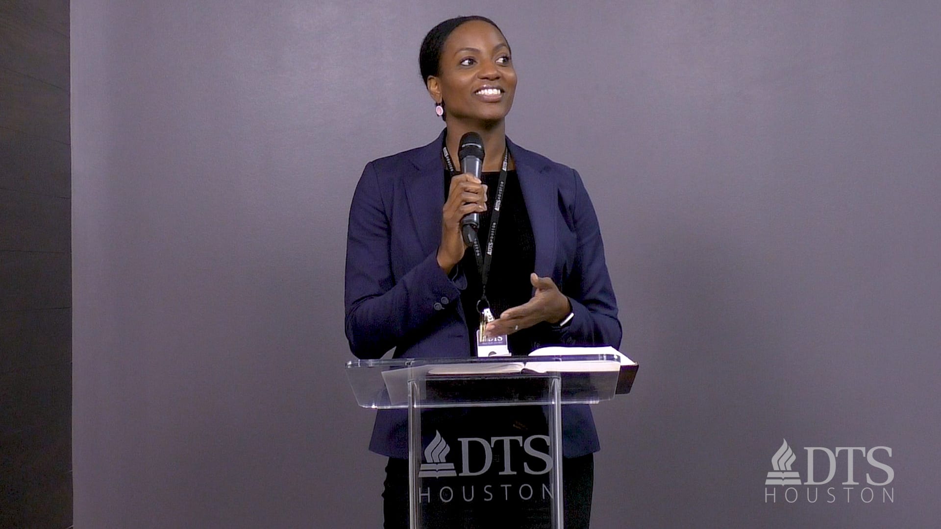 woman standing at podium speaking at DTS Chapel