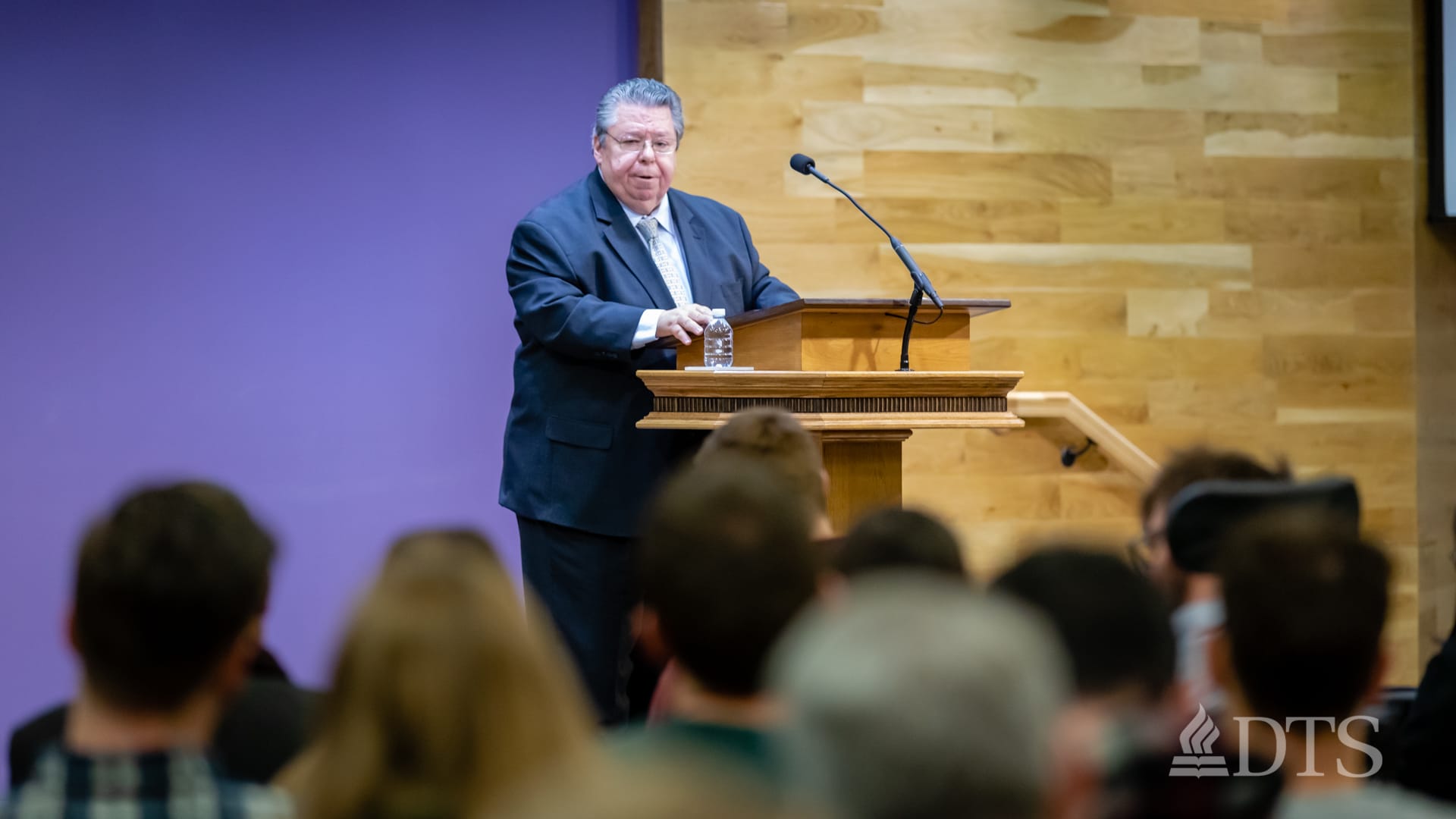 Dr. Mark Bailey standing at podium speaking at DTS Chapel