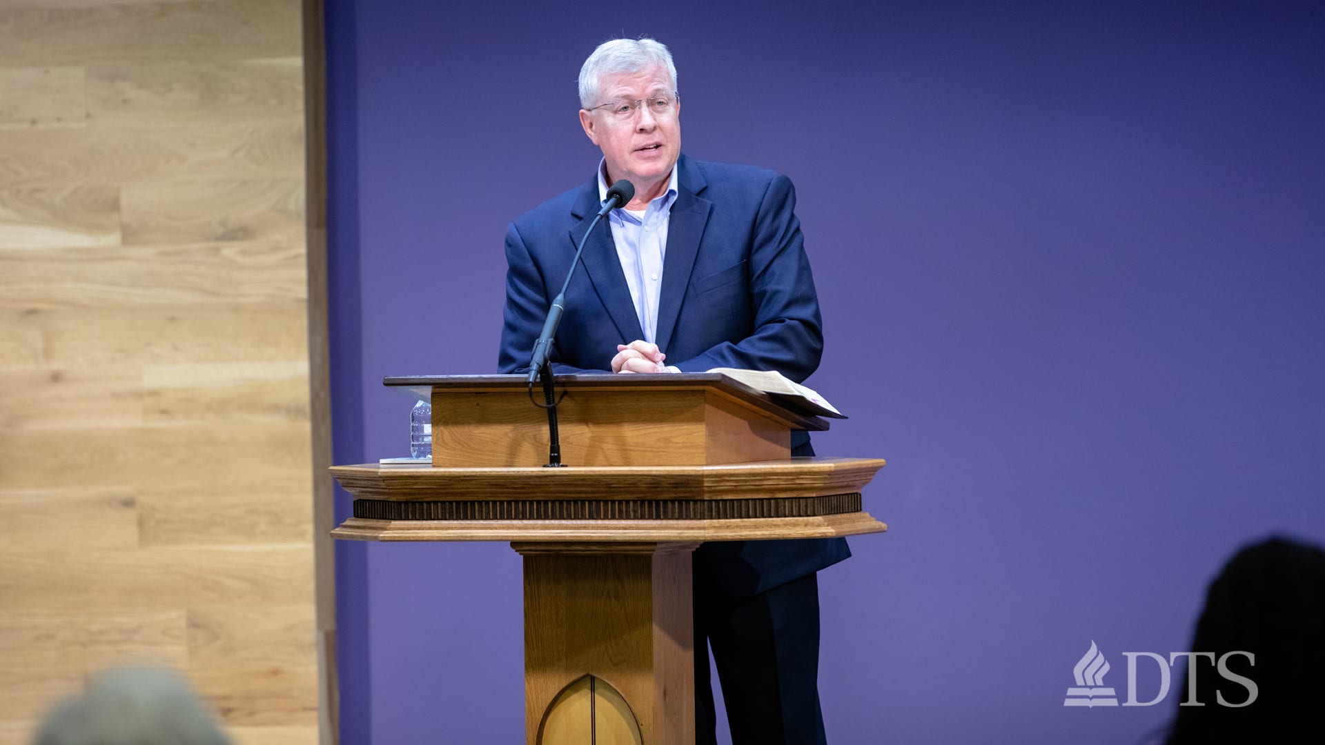 man standing at podium speaking at DTS Chapel