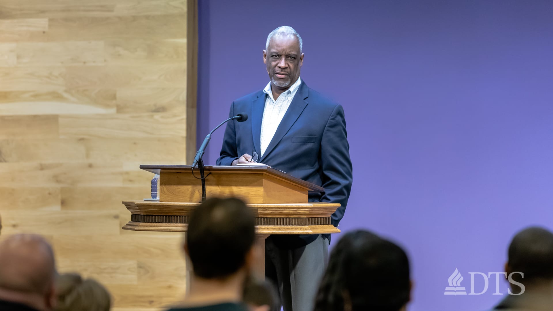 man standing at podium speaking at DTS Chapel