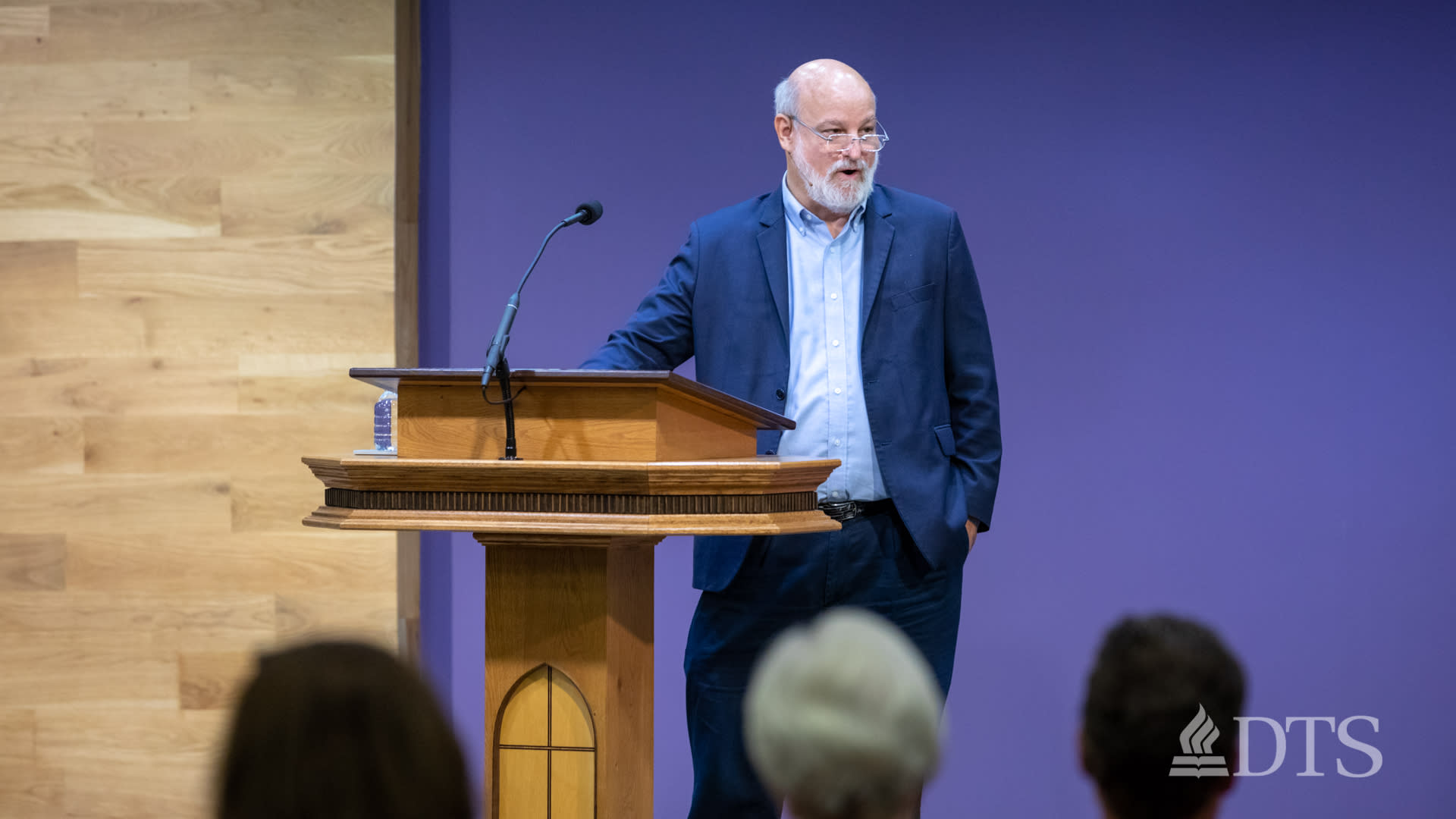 Dr. Bock standing at podium while speaking at DTS Chapel