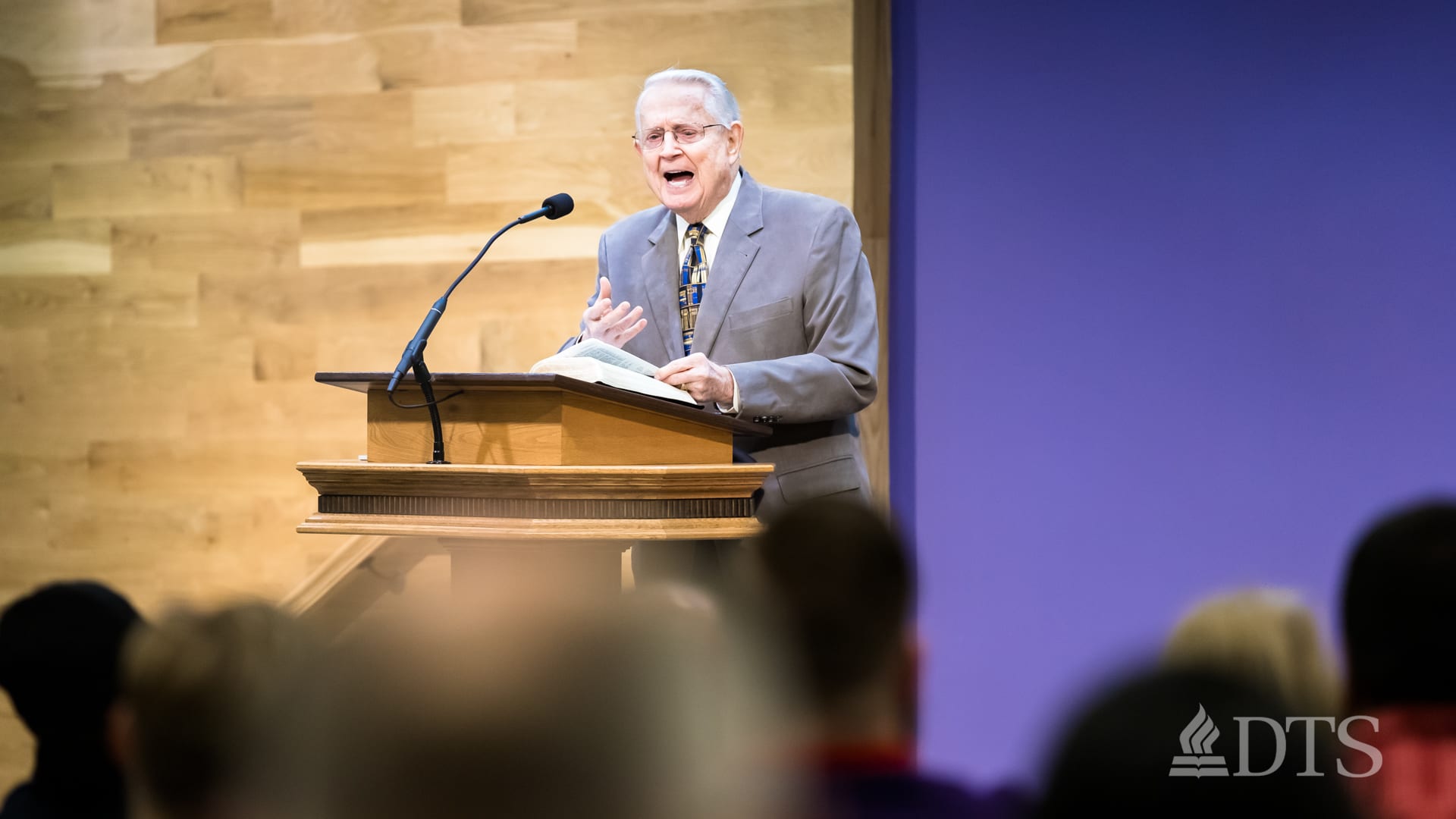 Dr. Chuck Swindoll standing at podium speaking at DTS Chapel