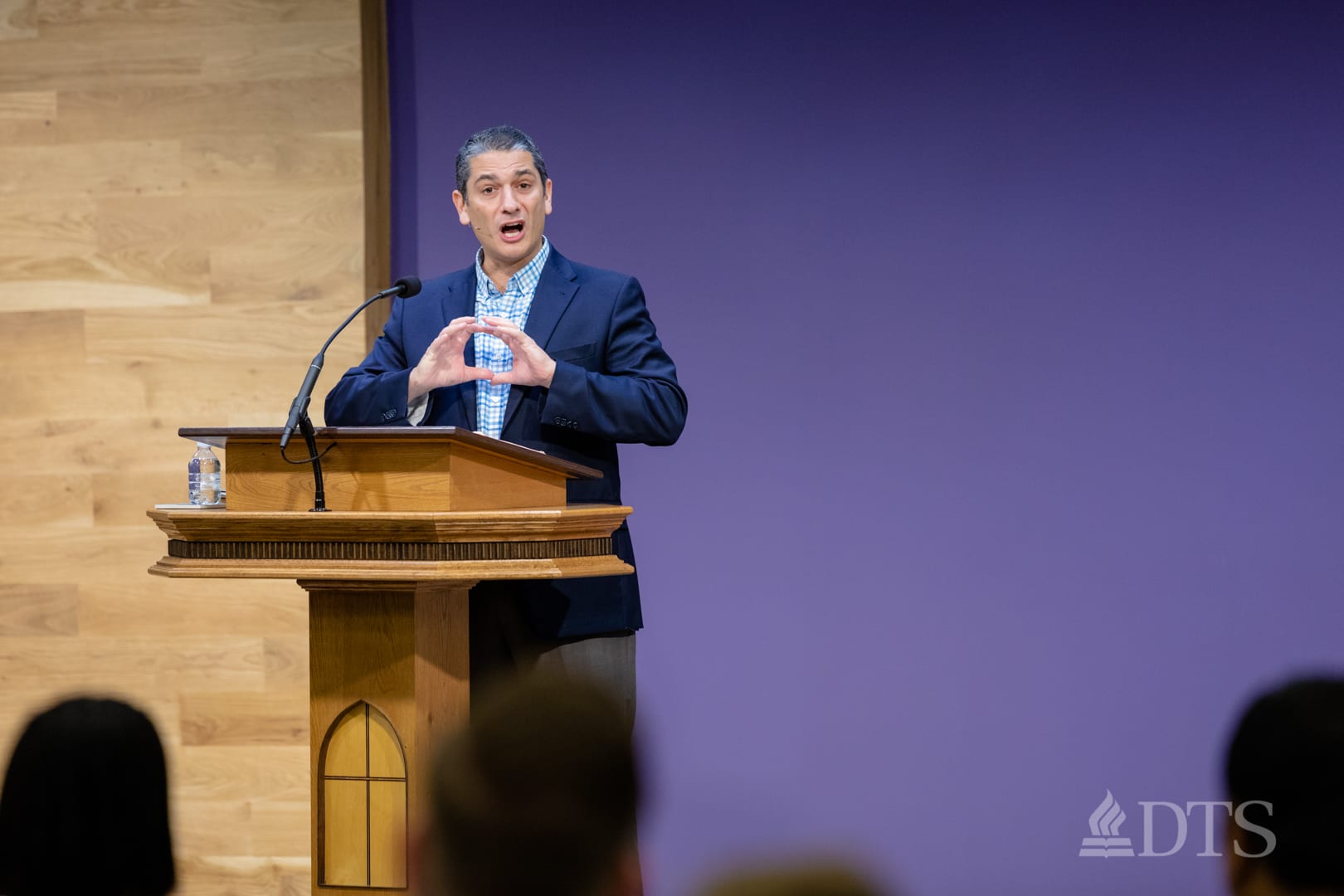 man standing at podium speaking at DTS Chapel