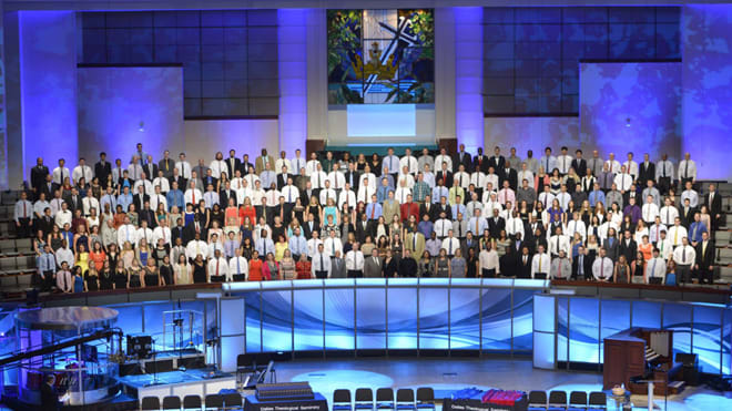 Graduates standing in Prestonwood Choir Loft prior to commencement