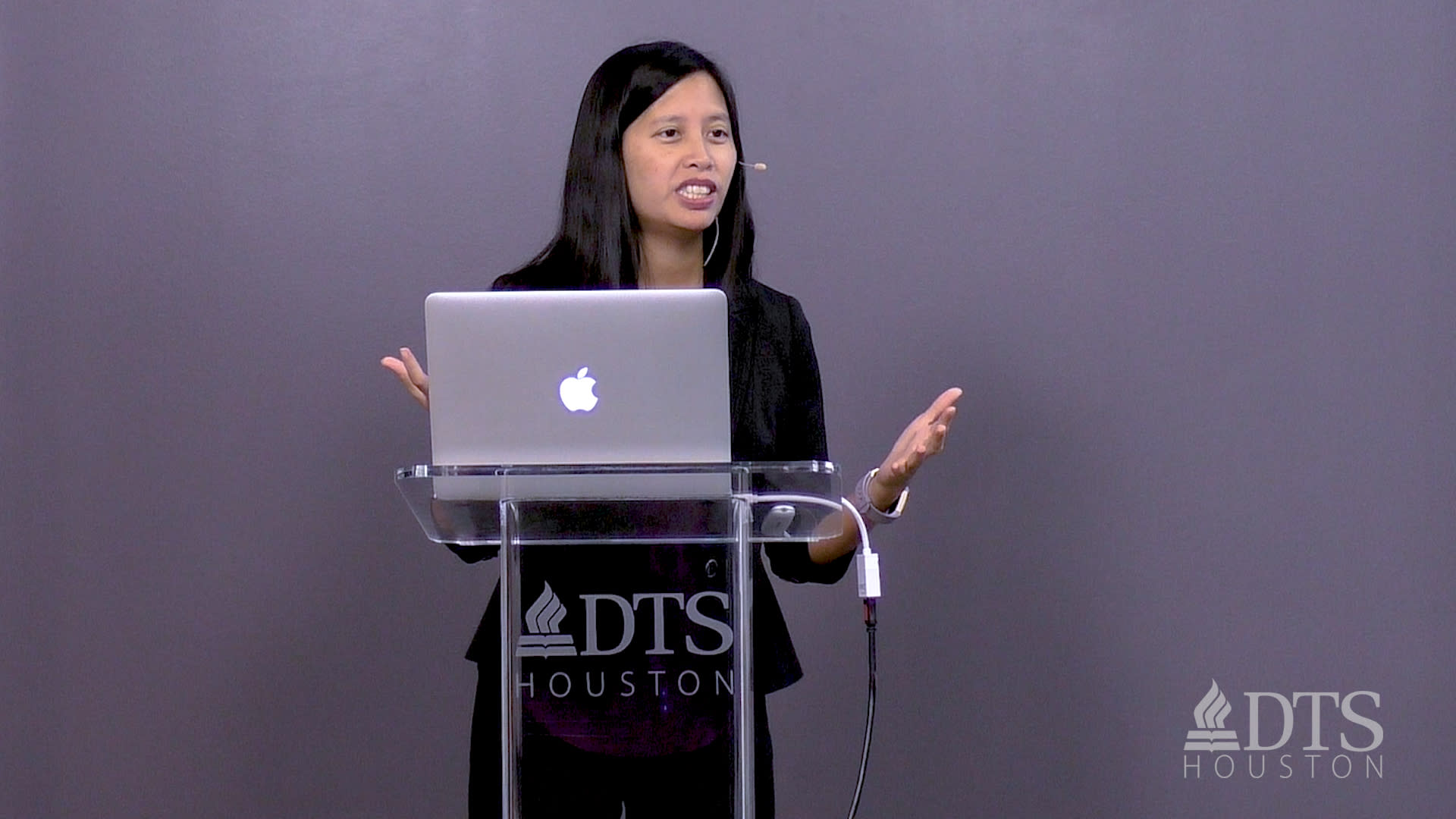 woman standing at podium speaking at DTS Chapel