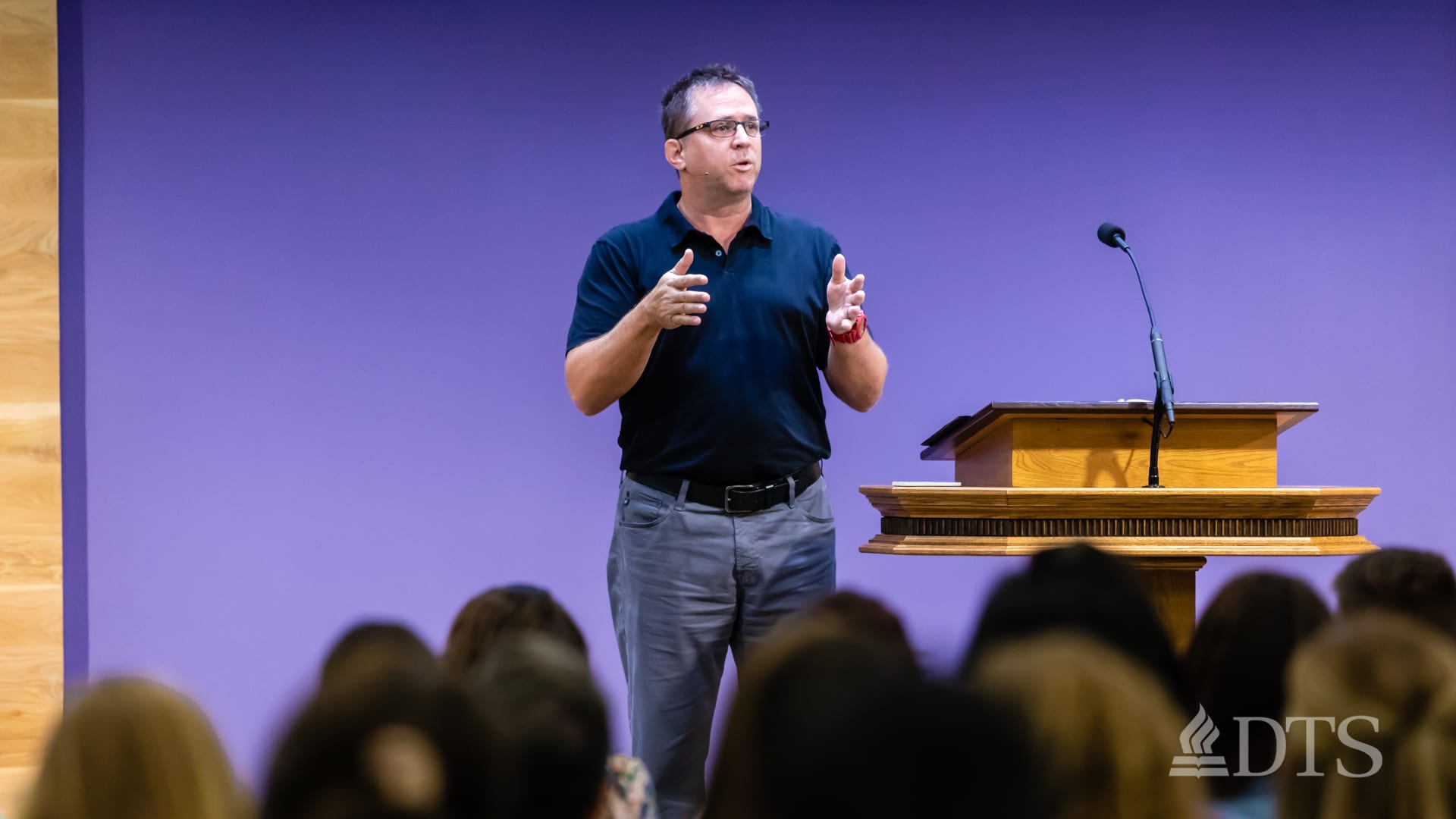 man standing near podium speaking at DTS Chapel