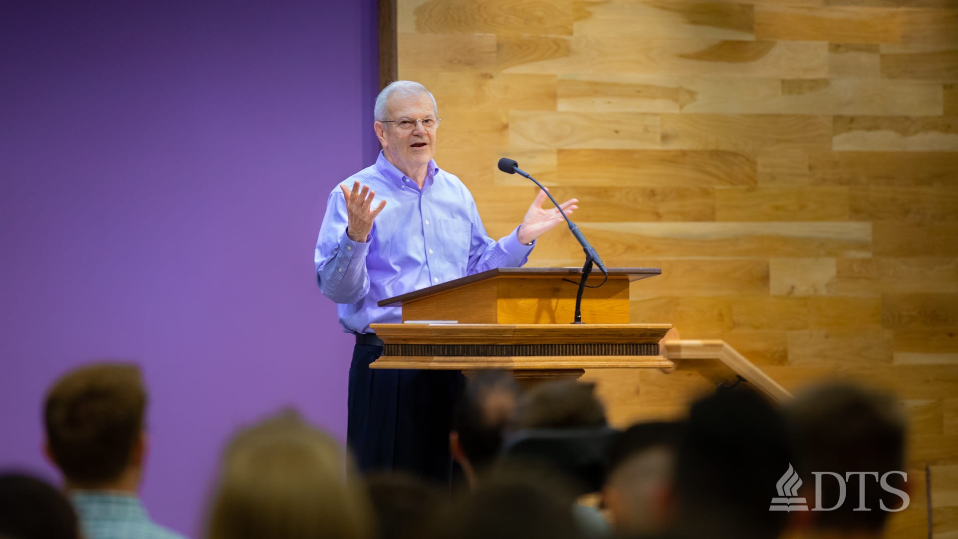 man standing at podium speaking at DTS Chapel