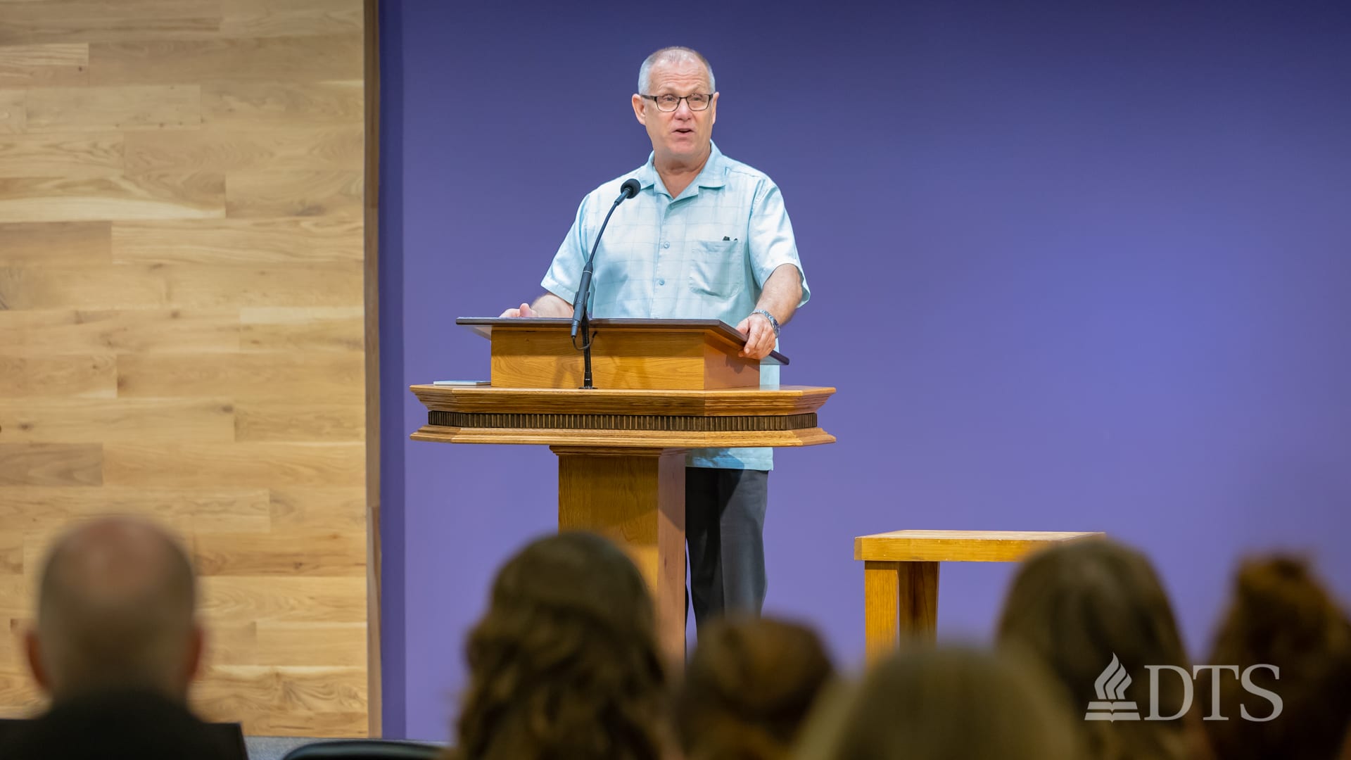 man standing at podium speaking at DTS Chapel
