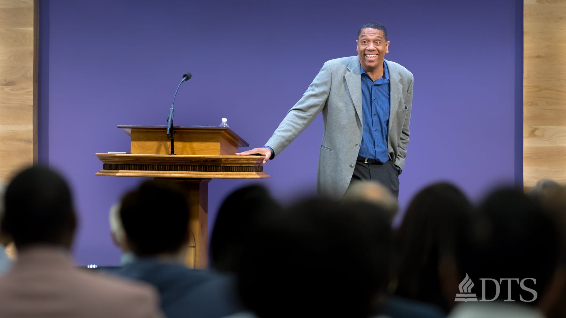 man standing near podium speaking at DTS Chapel