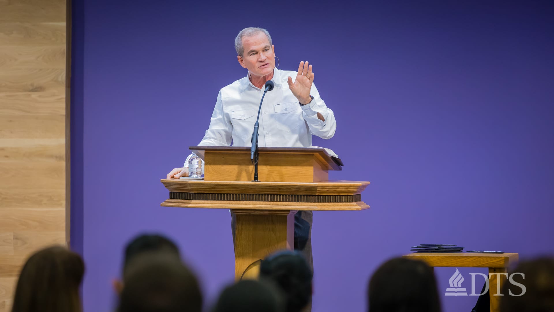 man standing at podium speaking at DTS Chapel
