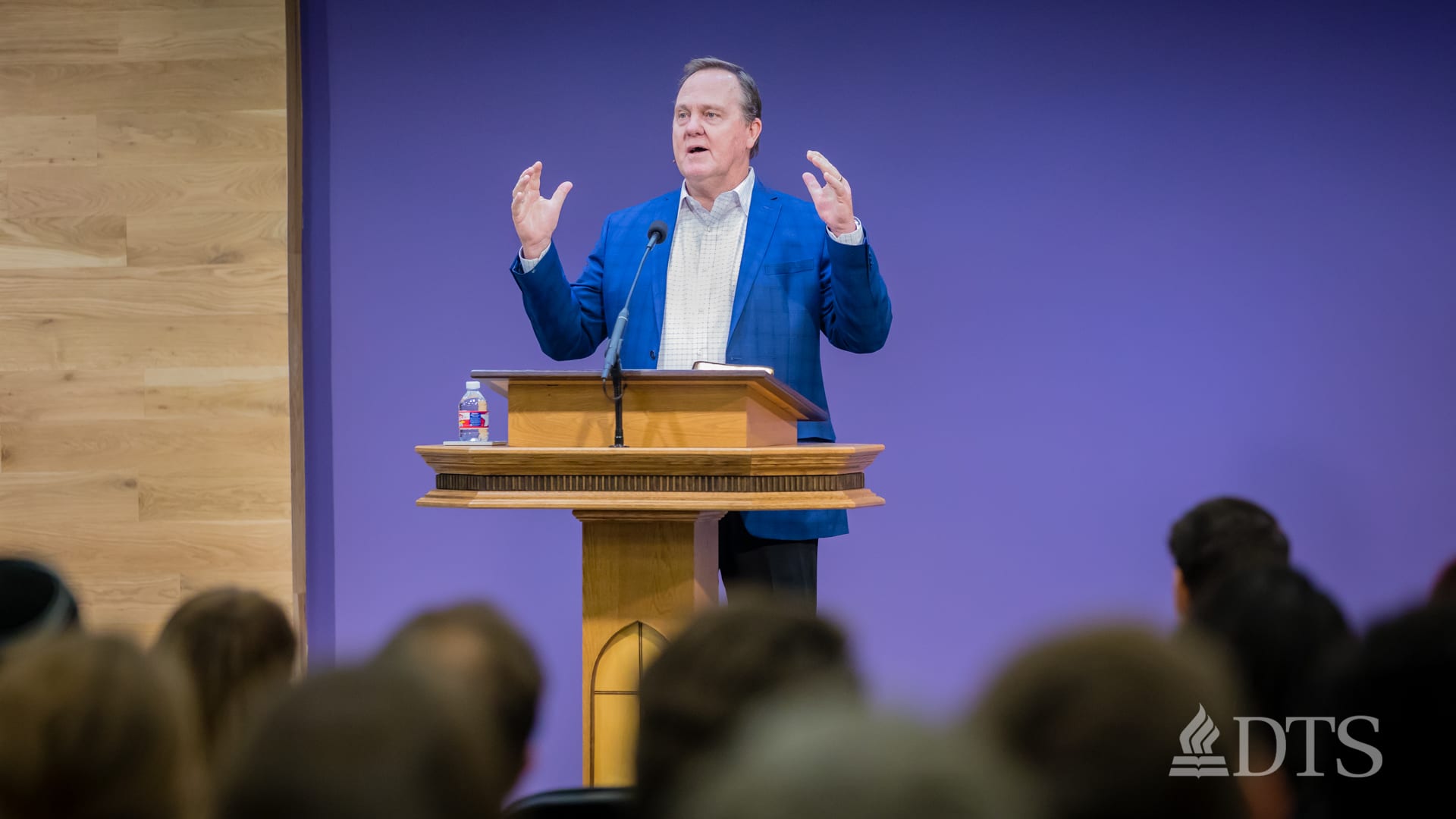 man standing at podium speaking at DTS Chapel