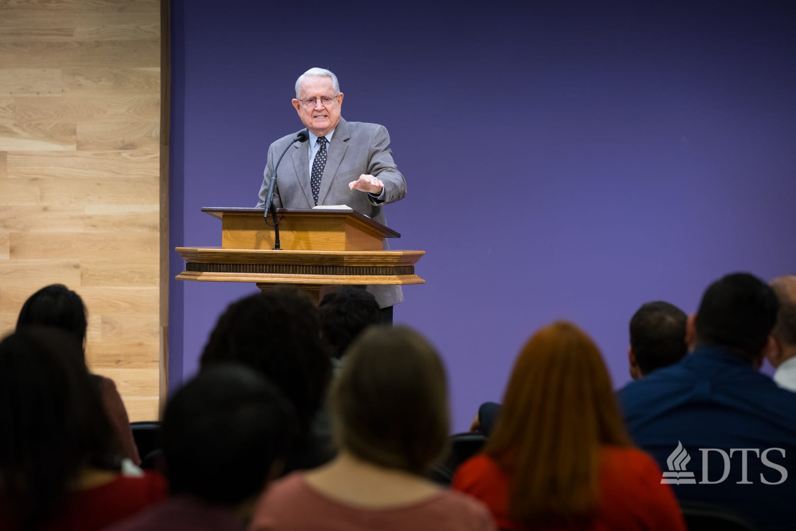 Dr. Chuck Swindoll standing at podium speaking at DTS Chapel