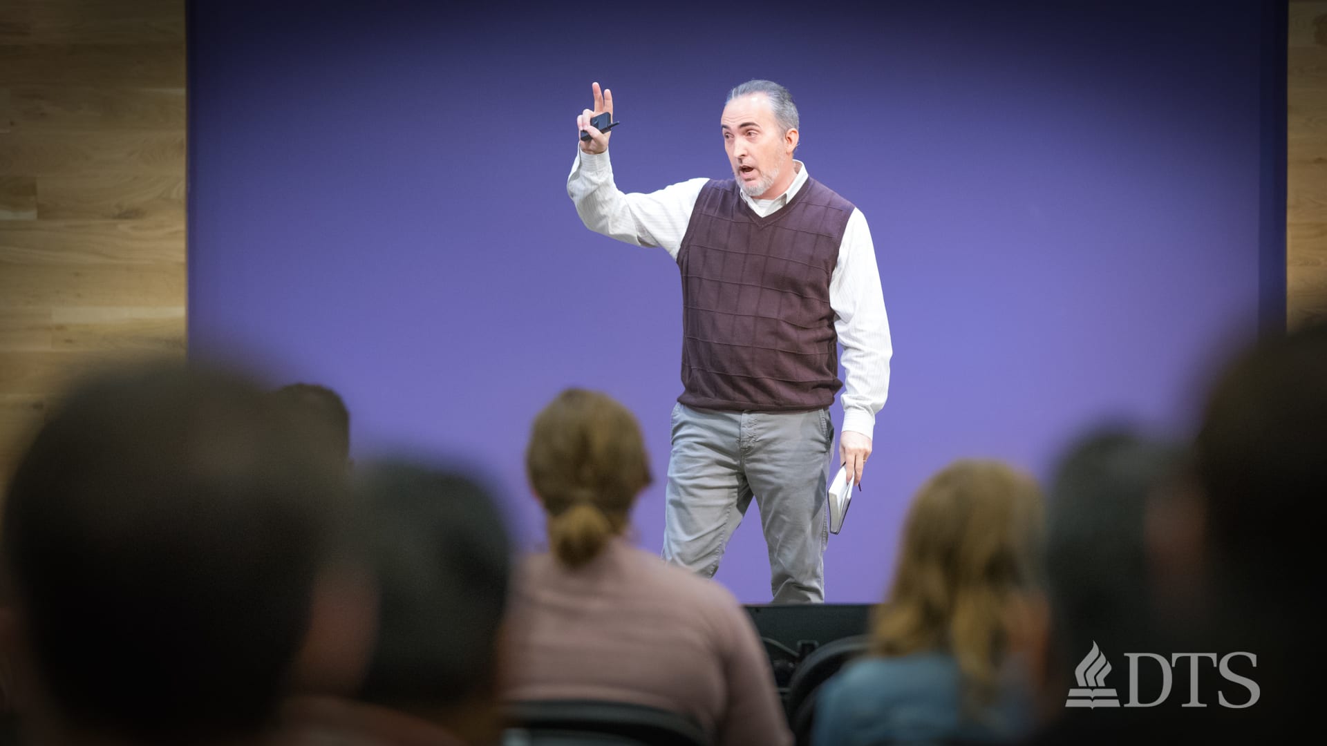 Dr. Mark Yarbrough standing on stage while speaking at DTS Chapel
