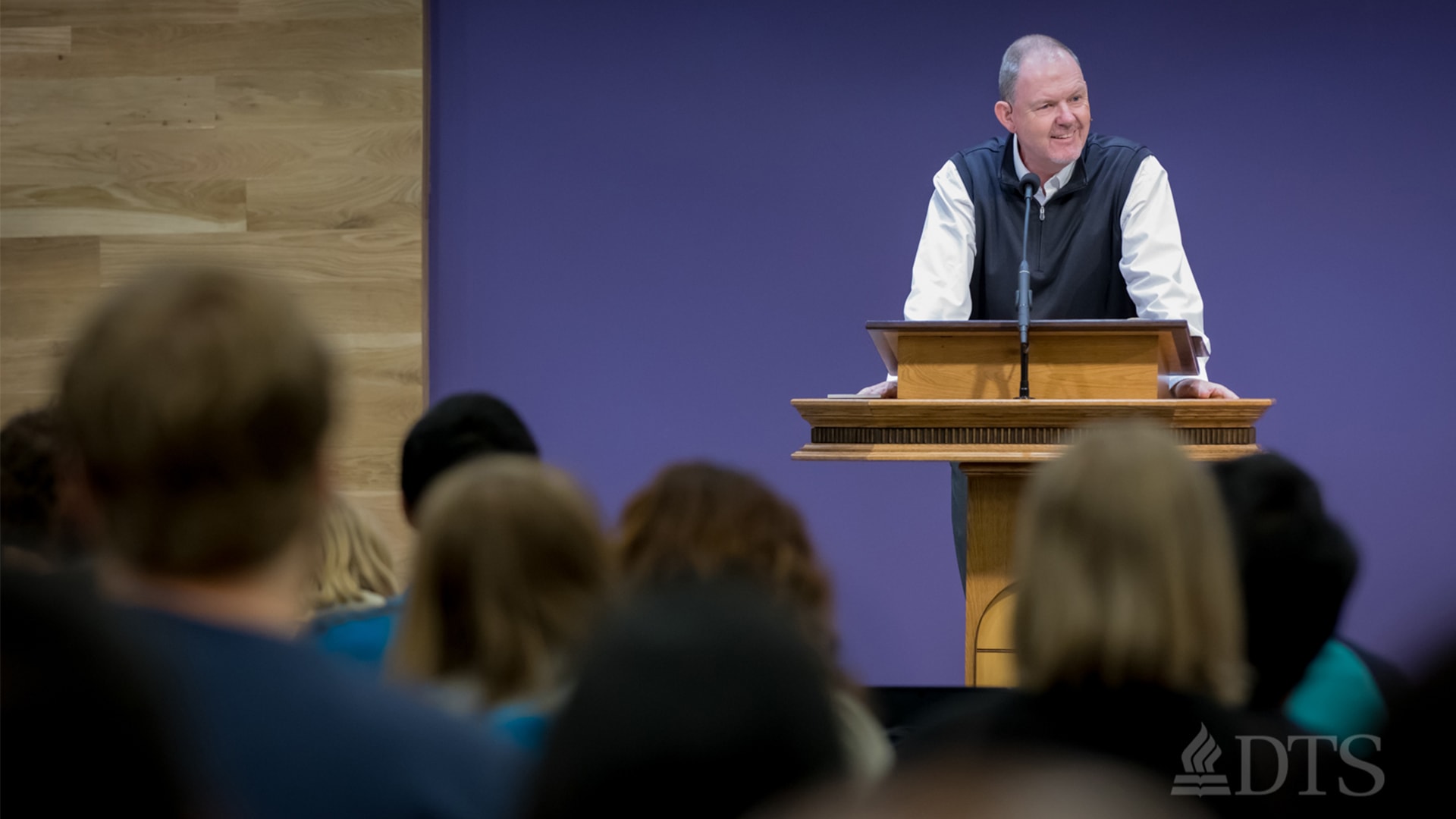 man standing at podium speaking at DTS Chapel