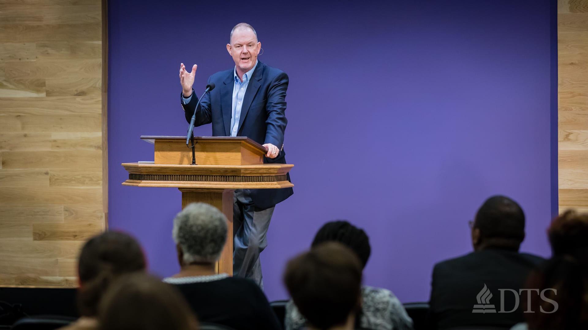 man standing at podium speaking at DTS Chapel