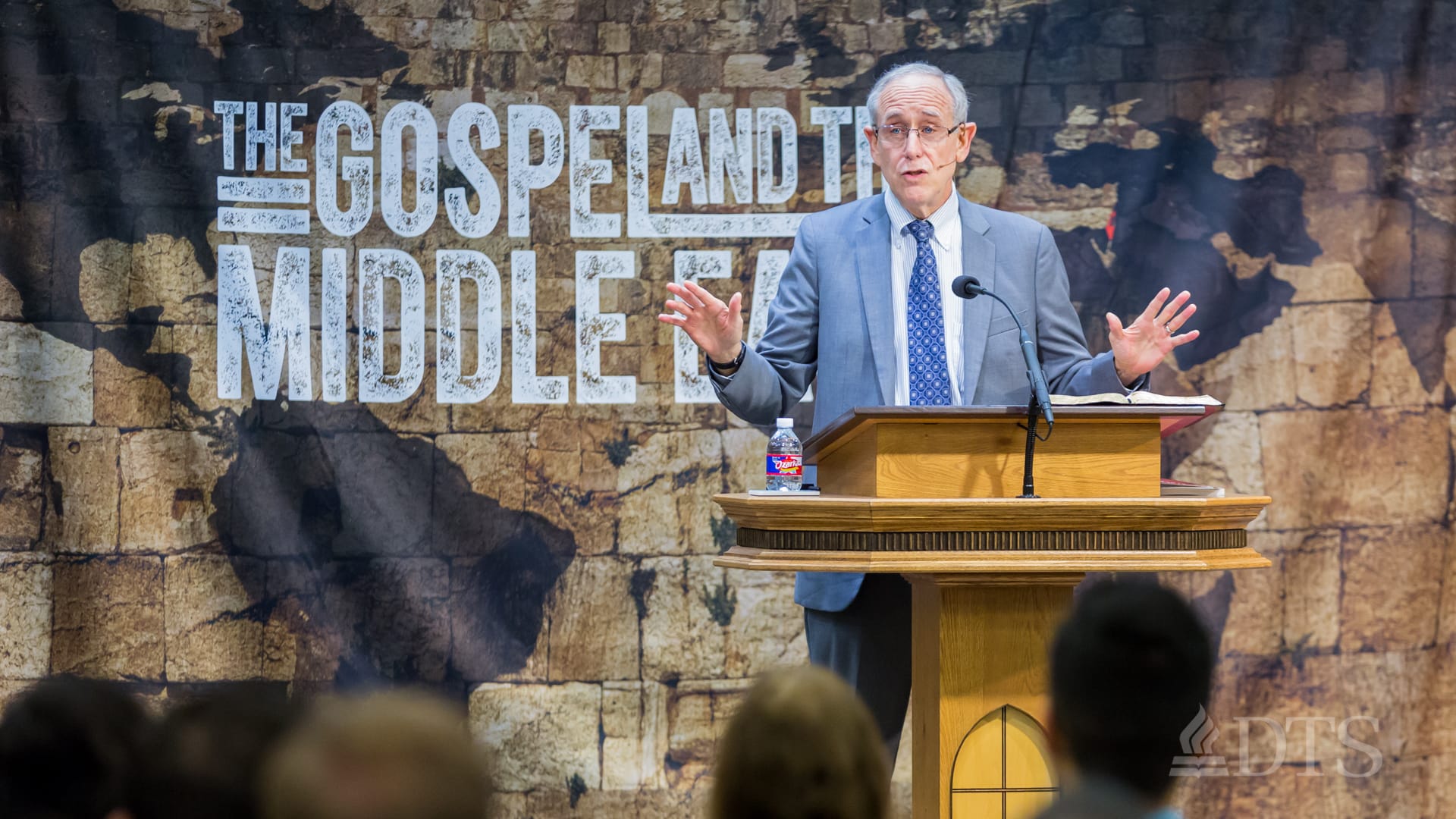 man standing at podium speaking at DTS Chapel