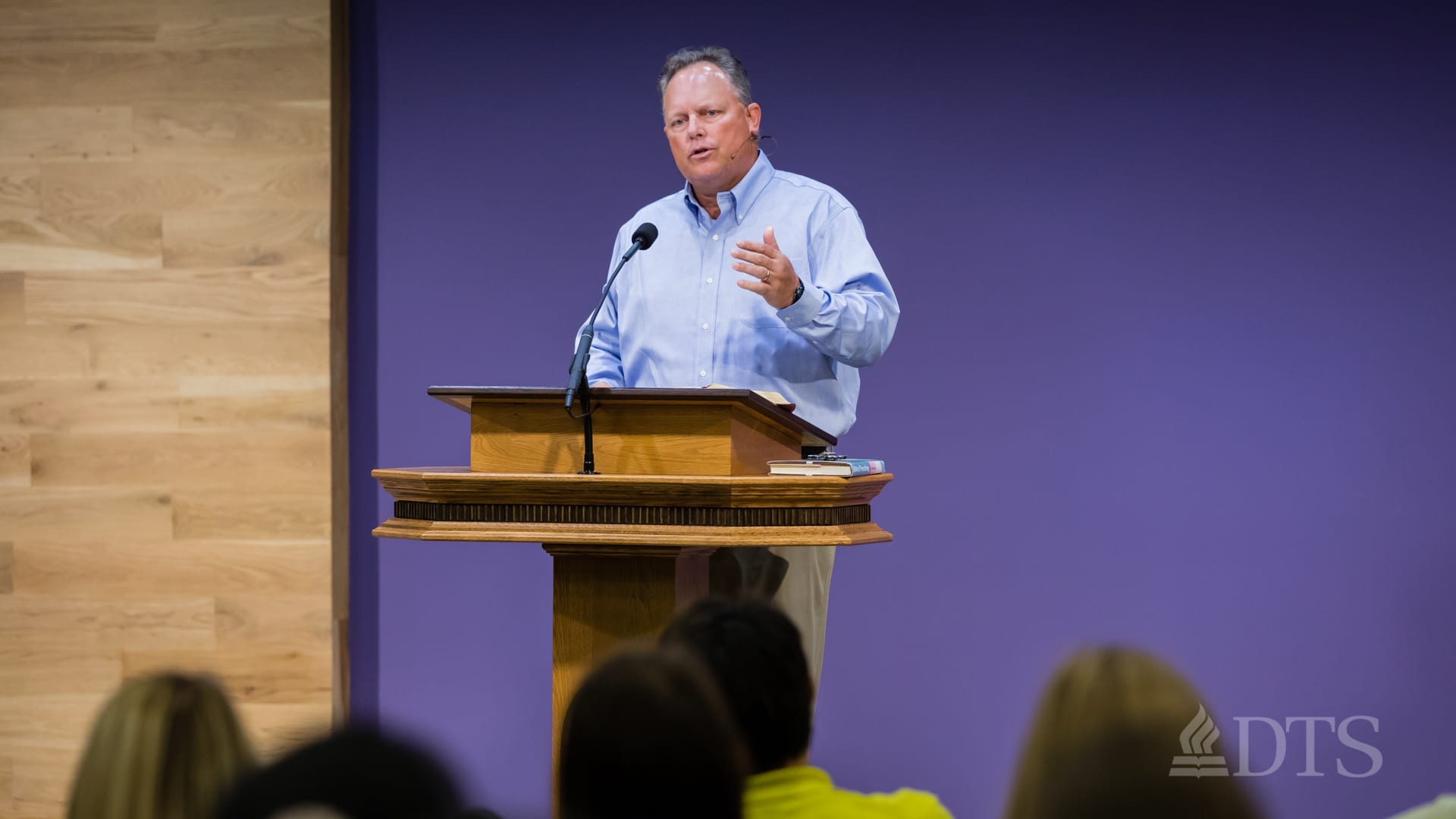 man standing at podium speaking at DTS Chapel