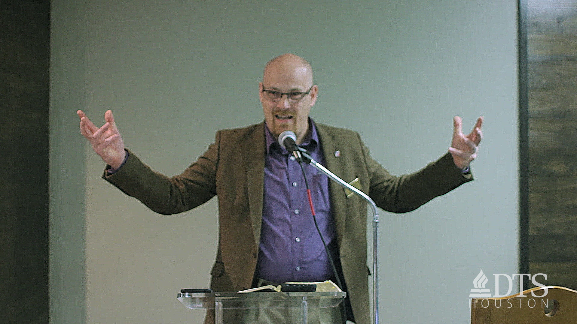 man standing at podium speaking at DTS Chapel