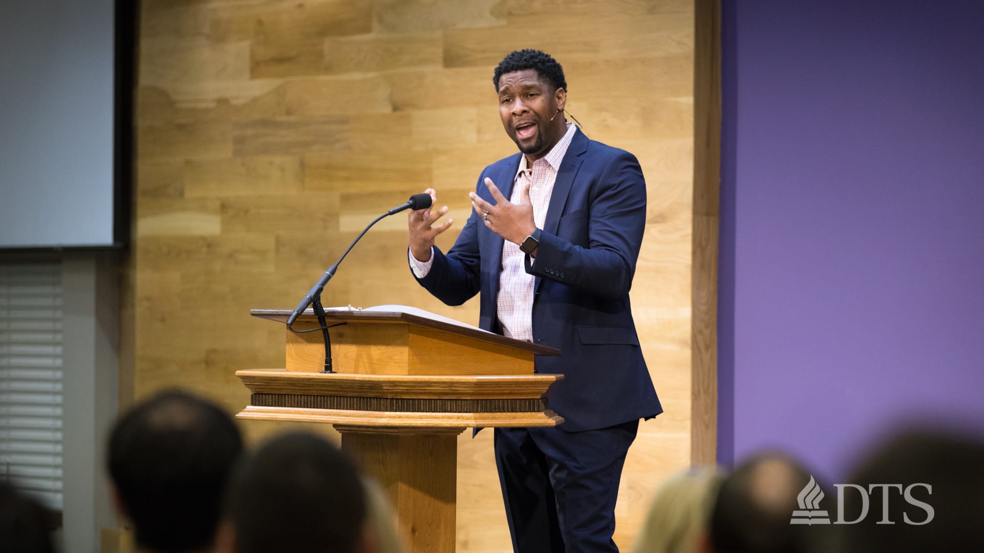 man standing at podium speaking at DTS Chapel