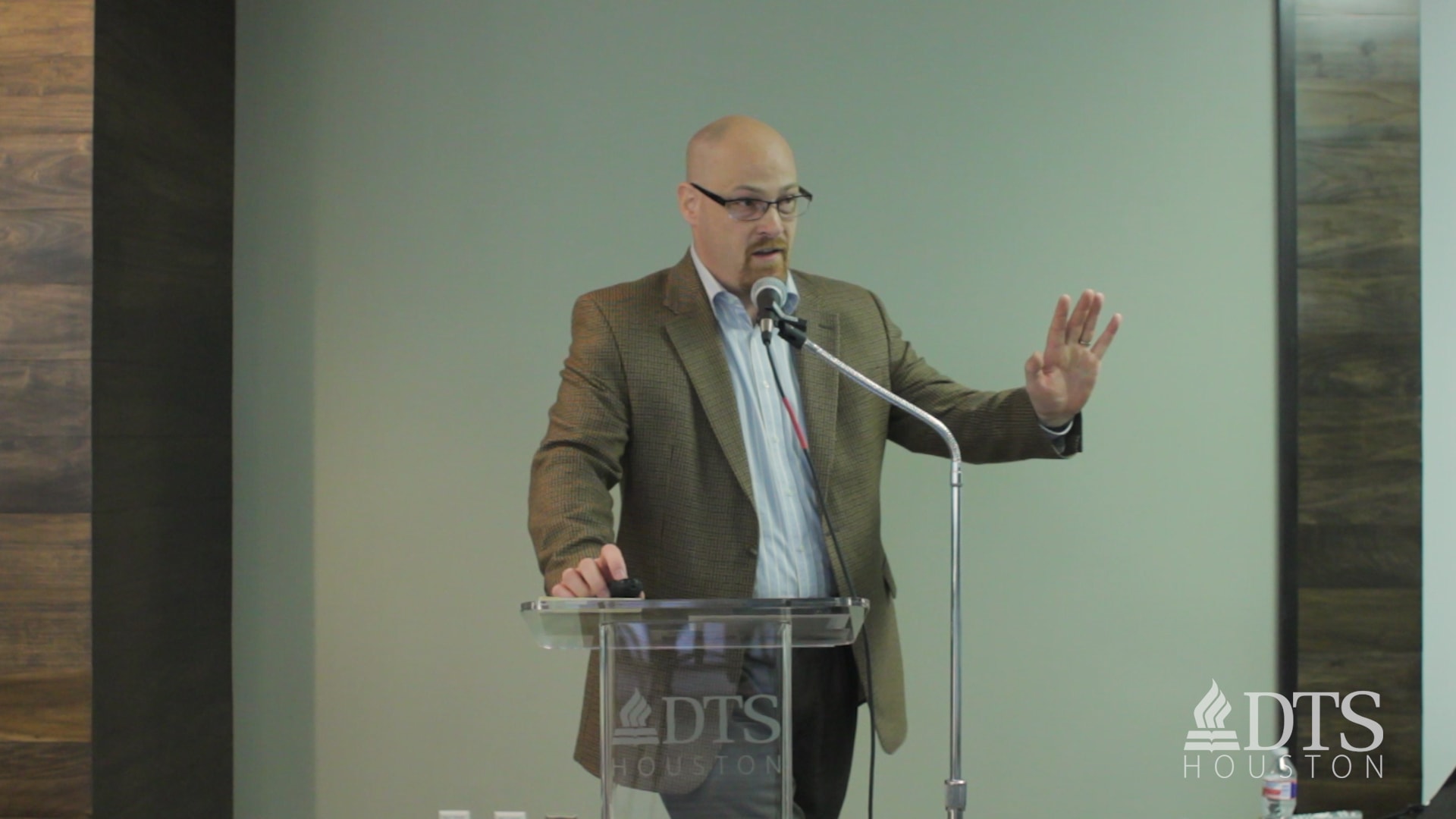 man standing at podium speaking at DTS Chapel