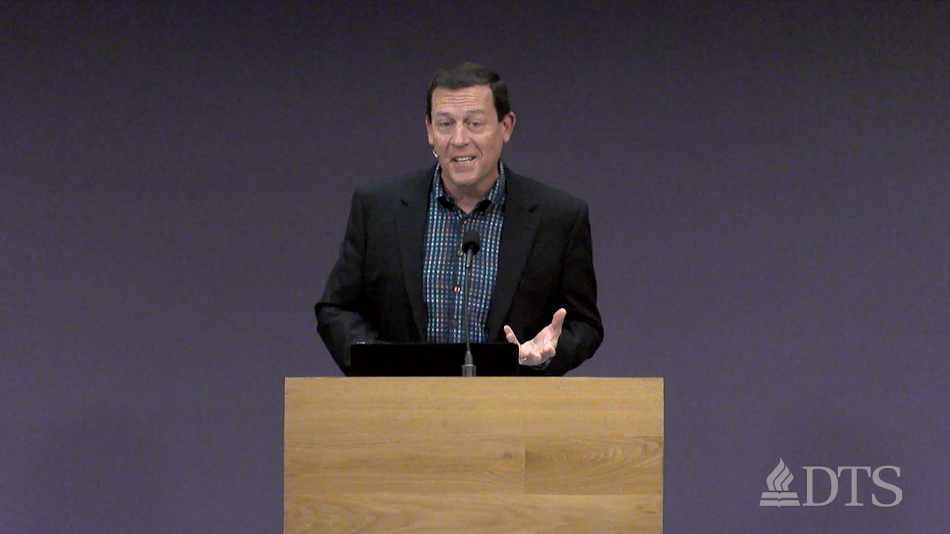 man standing at podium speaking at DTS Chapel
