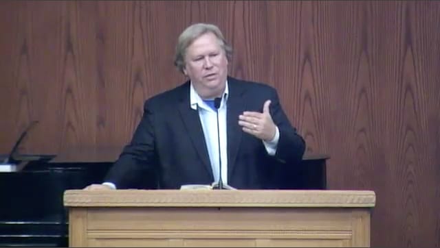 man standing at podium speaking at DTS Chapel
