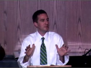 man standing at podium speaking at DTS WEC Week