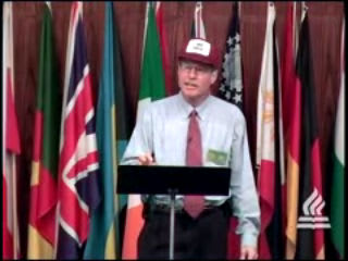 man standing at podium speaking at DTS WEC Week