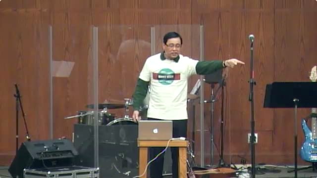 man standing on stage speaking at DTS WEC Week
