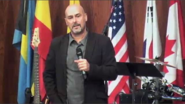 man standing on stage speaking at DTS WEC Week