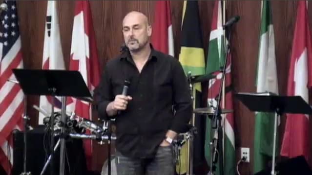man standing on stage speaking at DTS WEC Week