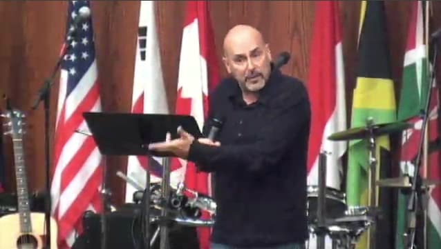 man standing on stage speaking at DTS WEC Week