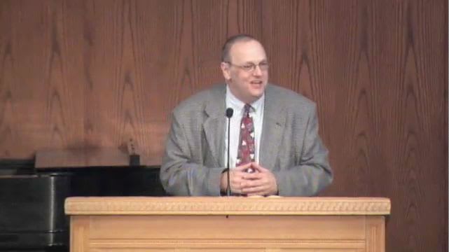 man standing at podium speaking at DTS Chapel
