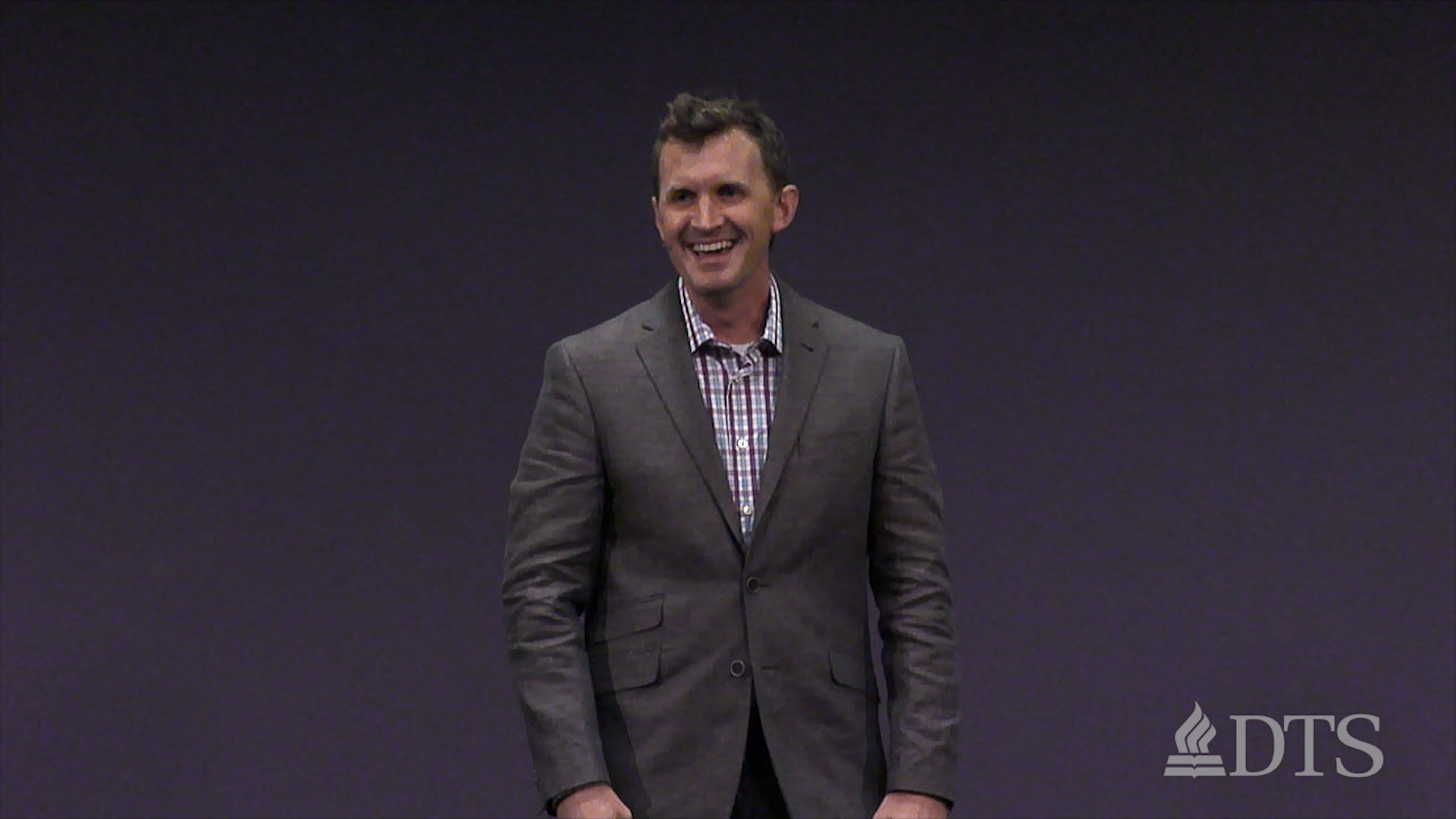 man standing on stage while speaking at DTS Chapel