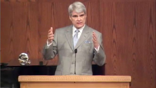 man standing at podium speaking at DTS Chapel