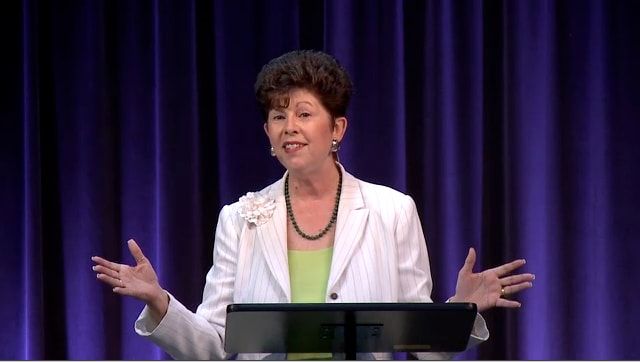 Dr. Sue Edwards standing at podium speaking at DTS Chapel