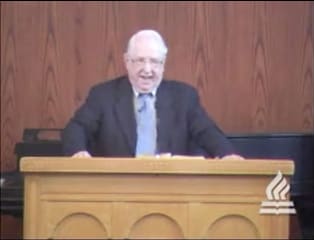 man standing at podium speaking at DTS Chapel