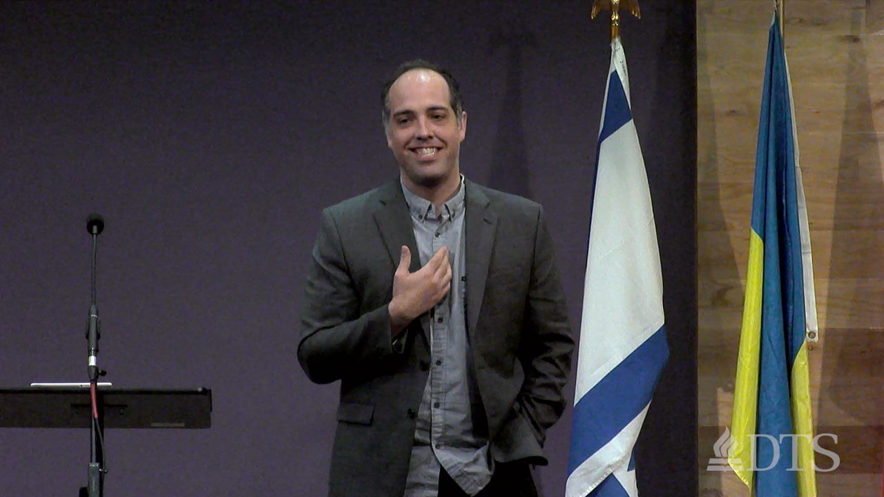 man standing next to podium speaking at DTS Chapel