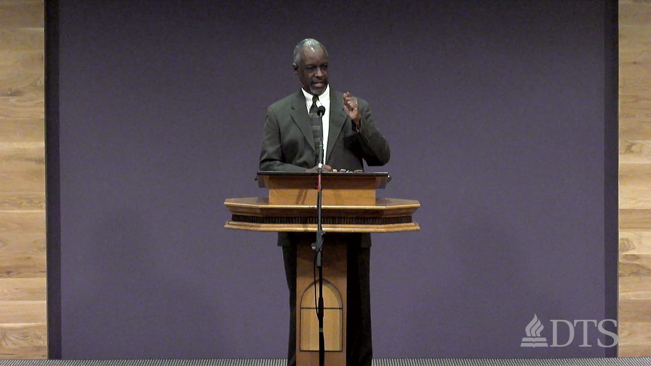 man standing at podium speaking at DTS Chapel