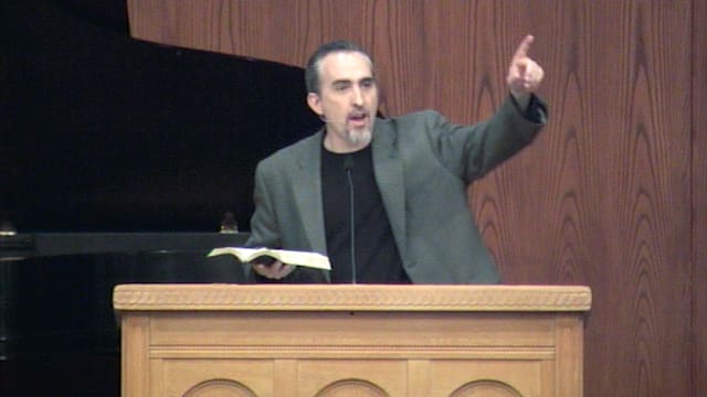 Dr. Mark Yarbrough standing at a podium speaking at DTS Chapel