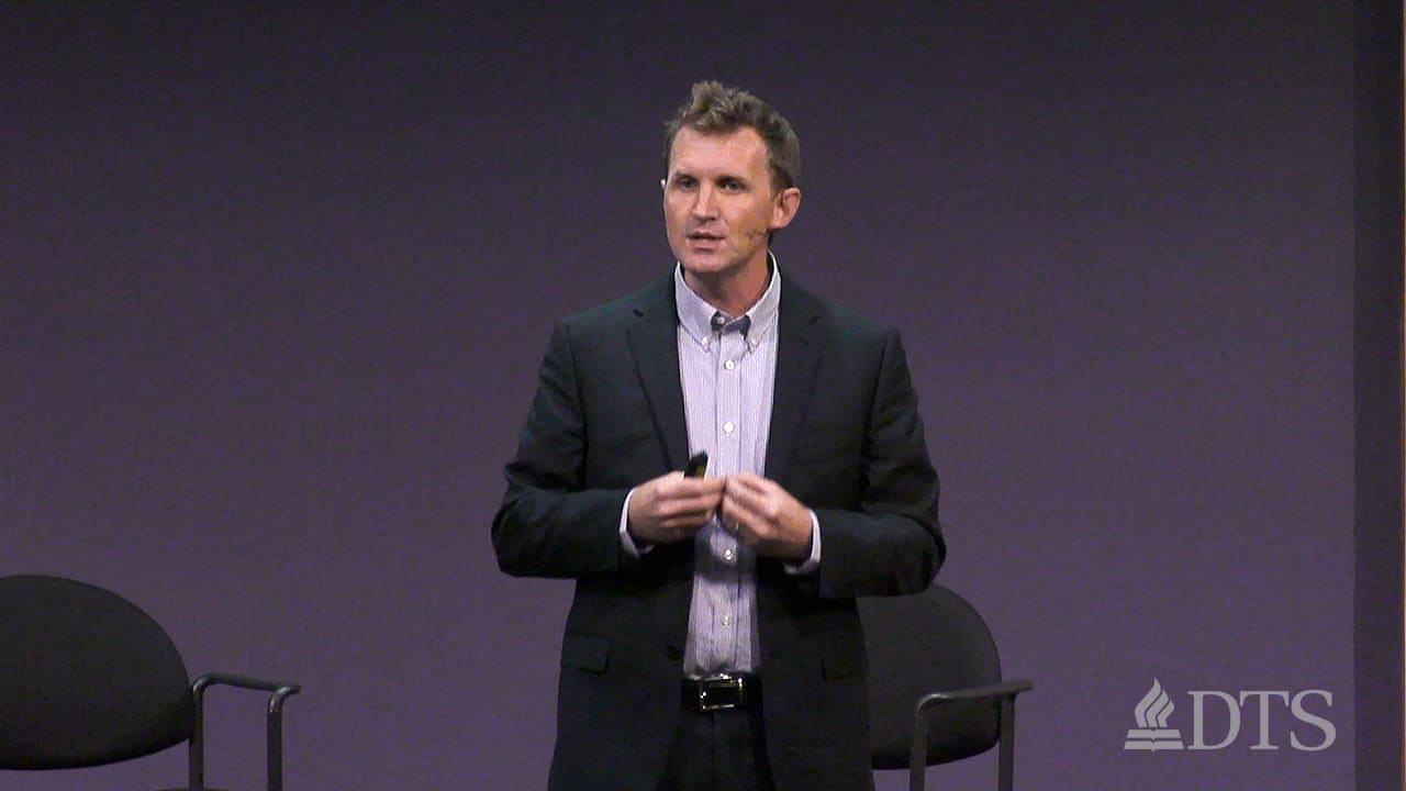 man standing on stage speaking at DTS Chapel