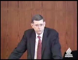 man standing at podium speaking at DTS Chapel