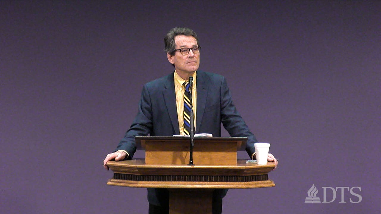 man standing at podium speaking at DTS Chapel