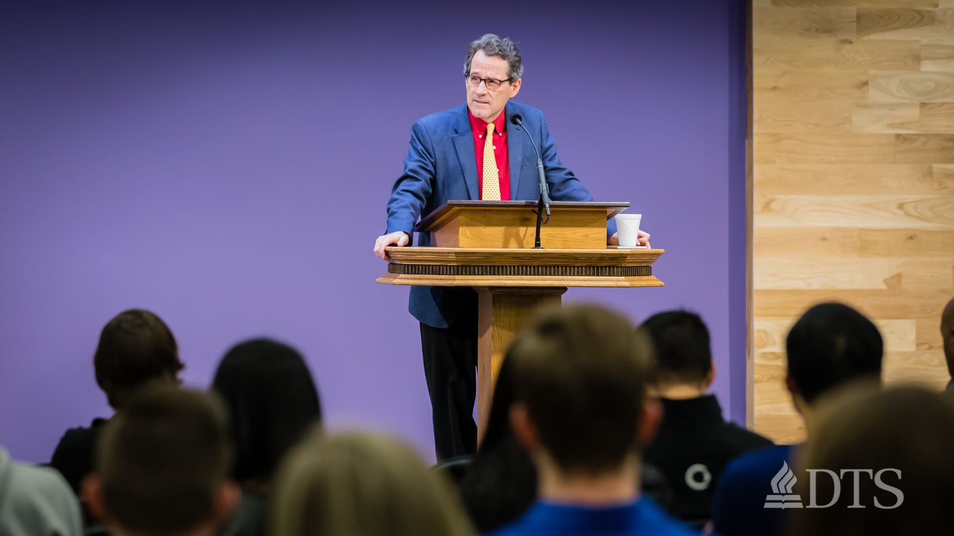 man standing at podium speaking at DTS Chapel
