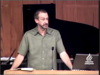 man standing at podium speaking at DTS Chapel
