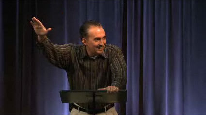 Dr. Mark Yarbrough standing at a podium speaking at DTS Chapel